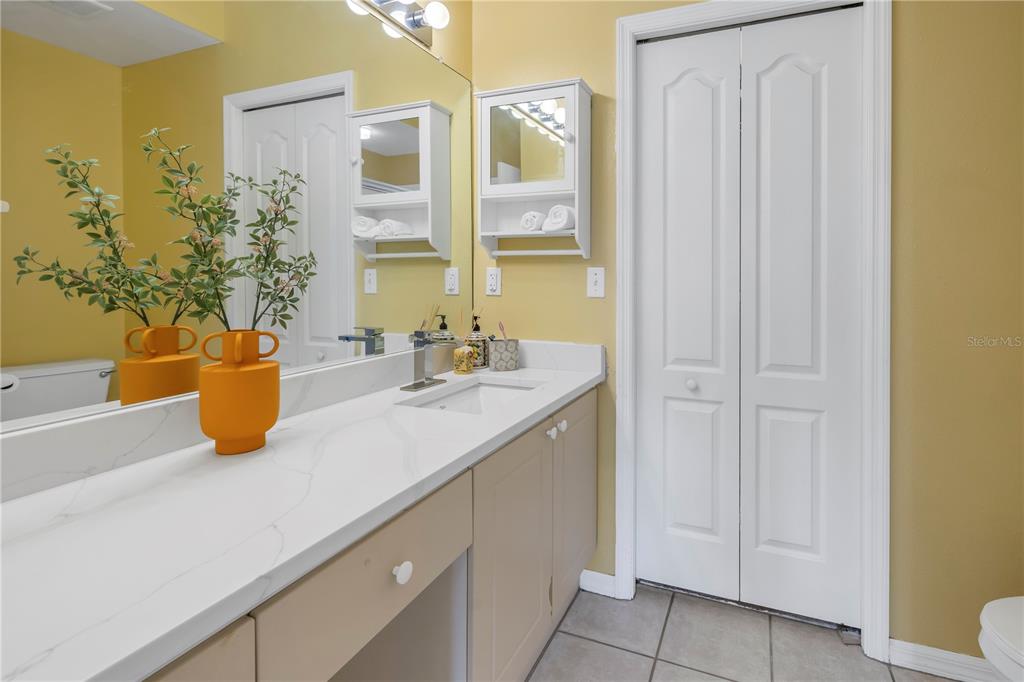1050 Starkey Road, Unit 2201 Largo, FL 33771 - Photo 46 of 66 a bathroom with a sink a mirror and a shower