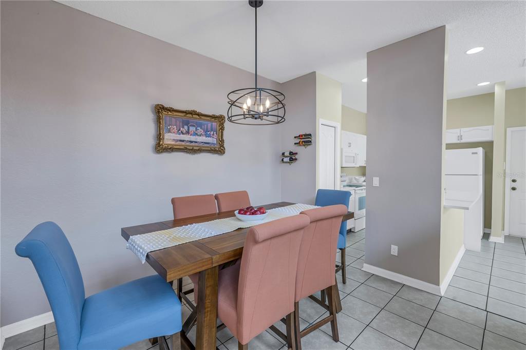 1050 Starkey Road, Unit 2201 Largo, FL 33771 - Photo 9 of 66 a view of a dining room with furniture wooden floor and a chandelier