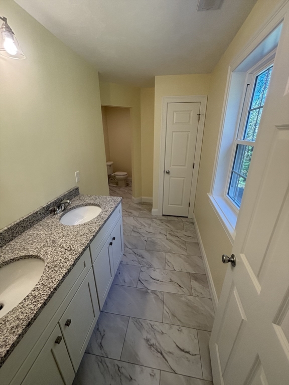 14 A Welch Avenue, Unit A Rutland, MA 01543 - Photo 12 of 25 a spacious bathroom with a granite countertop sink and a mirror