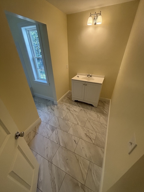 14 A Welch Avenue, Unit A Rutland, MA 01543 - Photo 14 of 25 a bathroom with a sink and mirror