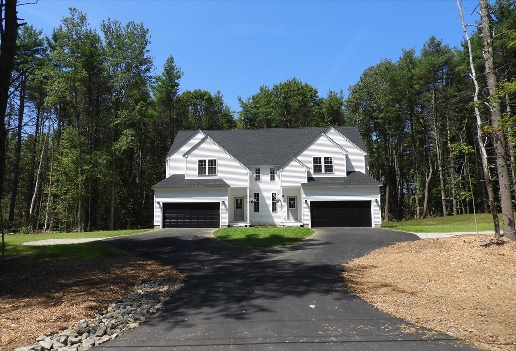 14 A Welch Avenue, Unit A Rutland, MA 01543 - Photo 2 of 25 a front view of a house with a yard and garage