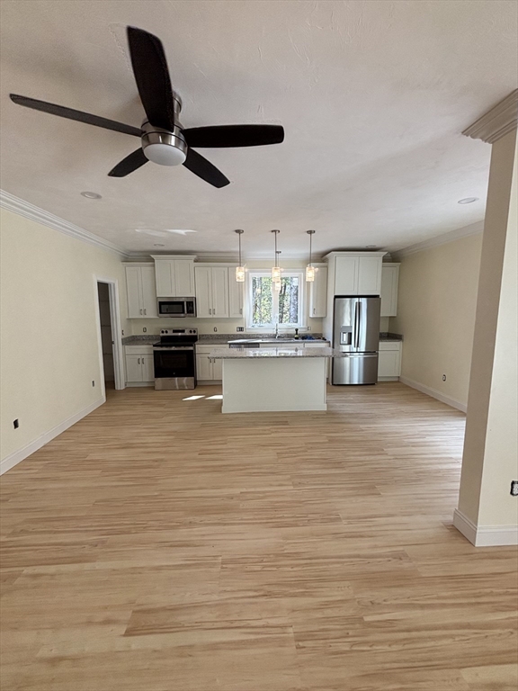 14 A Welch Avenue, Unit A Rutland, MA 01543 - Photo 4 of 25 a view of kitchen and empty room with wooden floor