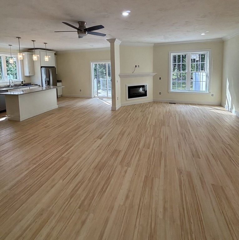 14 A Welch Avenue, Unit A Rutland, MA 01543 - Photo 6 of 25 an empty room with wooden floor a fireplace and windows