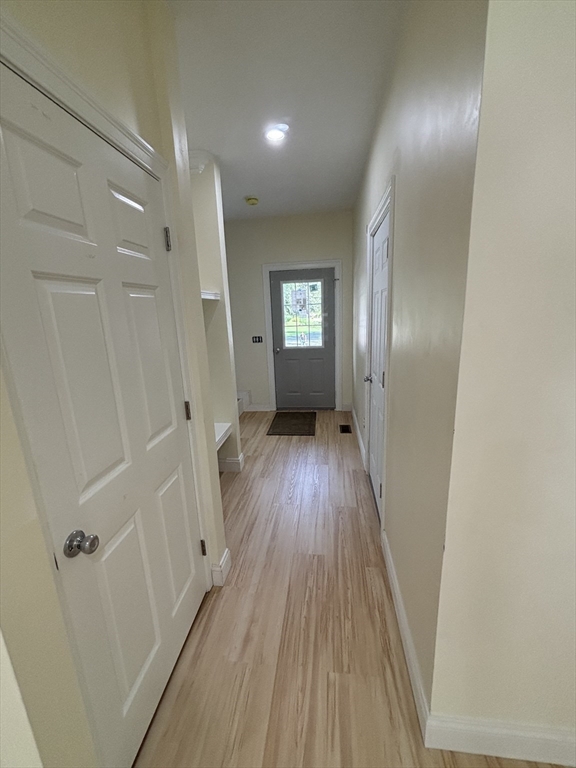 14 A Welch Avenue, Unit A Rutland, MA 01543 - Photo 9 of 25 a view of a hallway with wooden floor and a bathroom