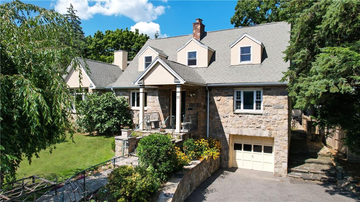 11 Glenwood Road Harrison, NY 10528 - Photo 1 of 1 a front view of a house with a garden