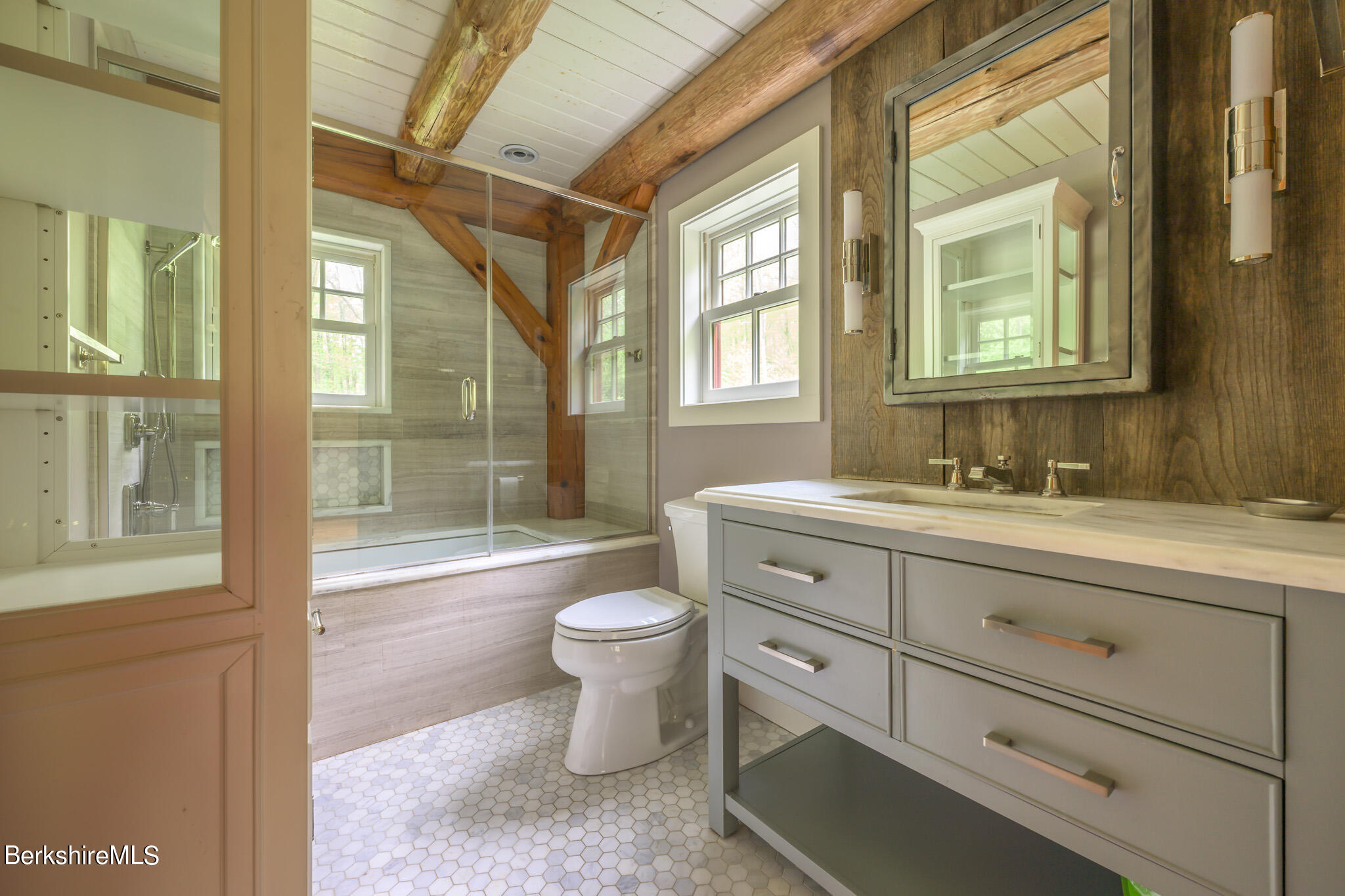 258 E Road Alford, MA 01266 - Photo 21 of 38 a bathroom with a granite countertop toilet a sink and a large mirror