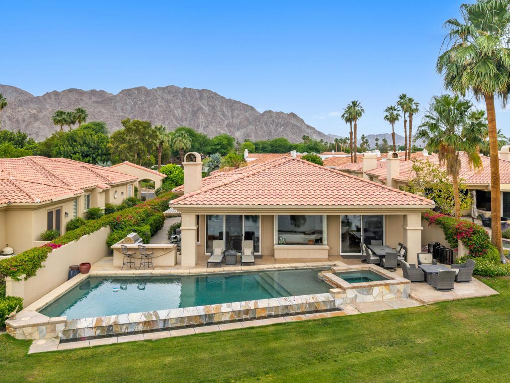 a view of house with garden space and swimming pool