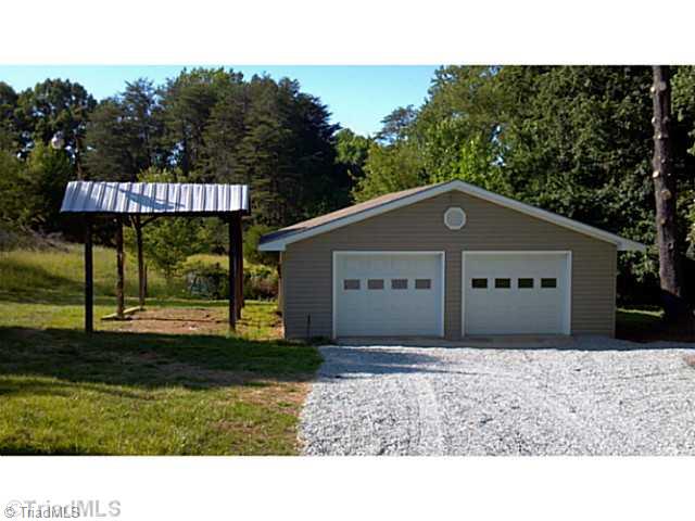 5606 Bunch Road Oak Ridge, NC 27310 - Photo 3 of 16 Parking Lot/Garage. HUGE 30x28 finished garage/workshop has room for whatever you have in mind. Covered RV/boat/tractor storage area is a huge plus.