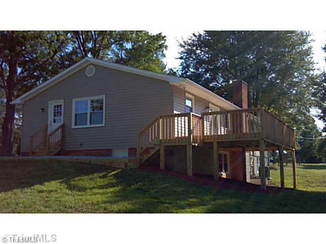 5606 Bunch Road Oak Ridge, NC 27310 - Photo 5 of 16 Patio/Deck. Brand new deck overlooks treed backyard and rear pasture area
