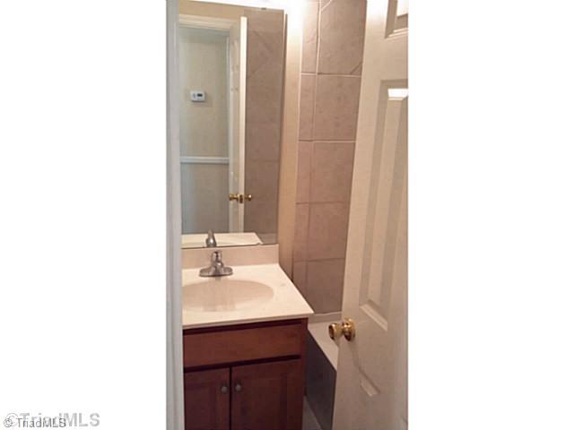 5606 Bunch Road Oak Ridge, NC 27310 - Photo 10 of 16 Bath. hall bath is all new, including tub, tile floor and surround, vanity, top, fixtures, etc
