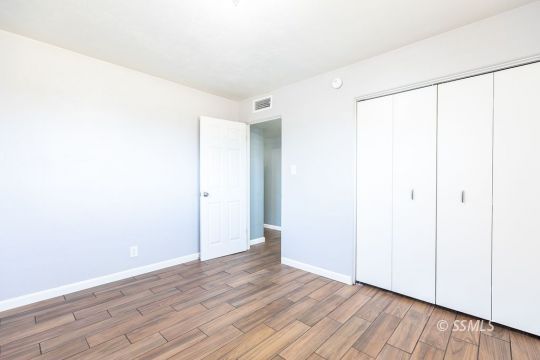 240 West Graaf Avenue Ridgecrest, CA 93555 - Photo 21 of 28 a view of an empty room with wooden floor