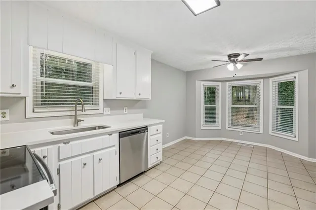 a view of a kitchen with sink cabinets and outdoor space