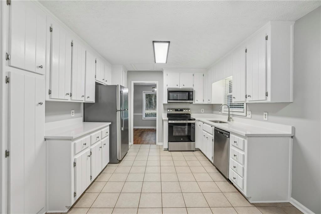 1076 Blackwell Road Marietta, GA 30066 - Photo 12 of 34 a kitchen with white cabinets appliances and sink