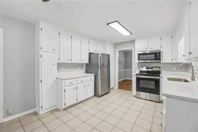 a kitchen with granite countertop cabinets and steel stainless steel appliances
