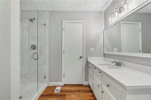 a bathroom with a double vanity sink and a mirror