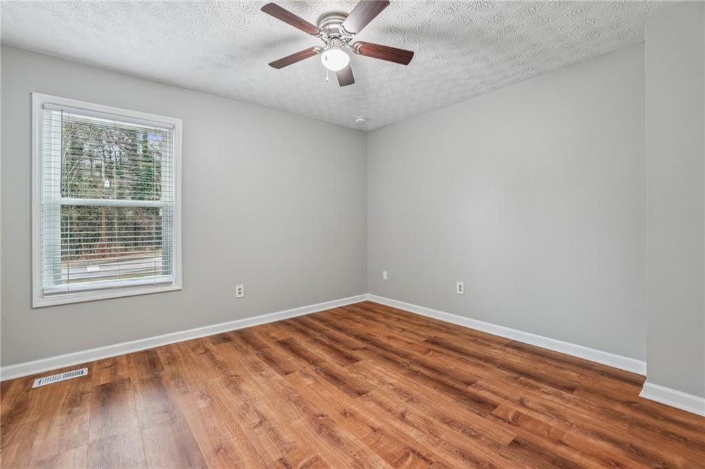 1076 Blackwell Road Marietta, GA 30066 - Photo 20 of 34 a view of an empty room with a window and wooden floor