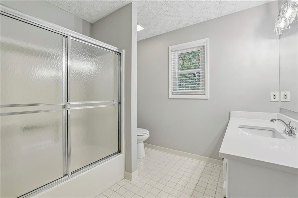 1076 Blackwell Road Marietta, GA 30066 - Photo 22 of 34 a bathroom with a sink toilet and shower