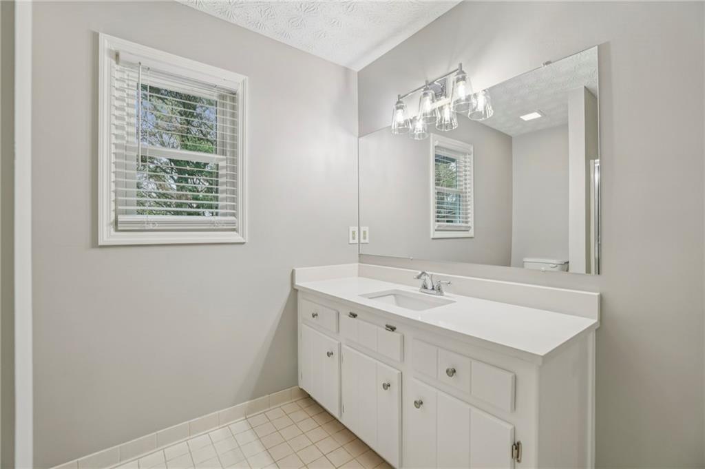 1076 Blackwell Road Marietta, GA 30066 - Photo 23 of 34 a bathroom with a double vanity sink and a mirror
