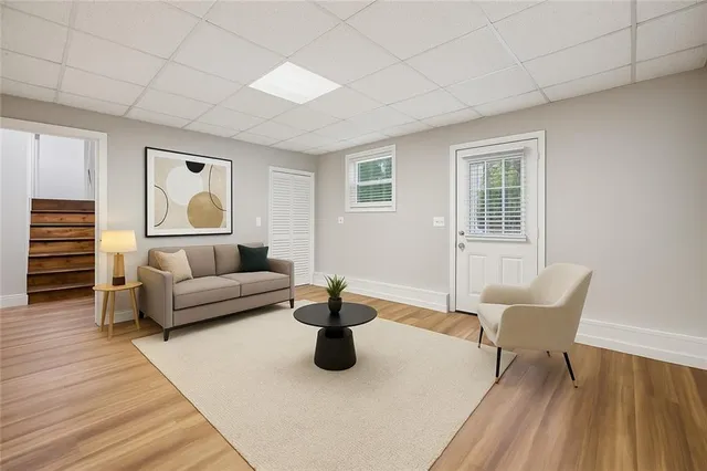 a living room with furniture and a potted plant