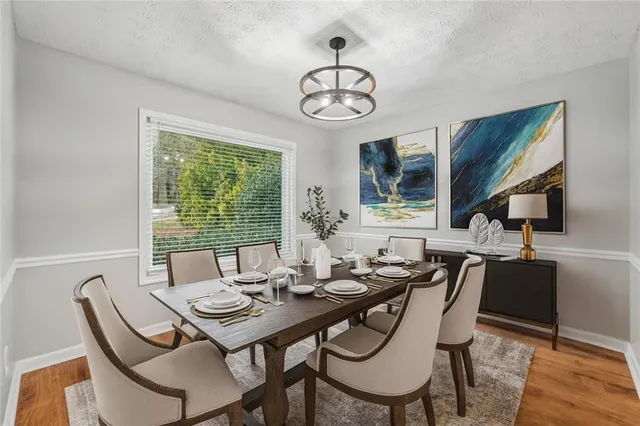 a view of a dining room with furniture window and wooden floor