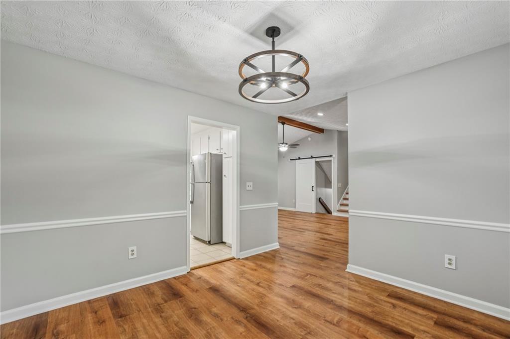 1076 Blackwell Road Marietta, GA 30066 - Photo 9 of 34 a view of empty room with wooden floor and window