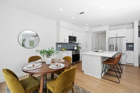 a kitchen with a dining table chairs and a sink