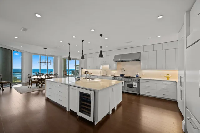 a kitchen that has a lot of cabinets in it and wooden floors
