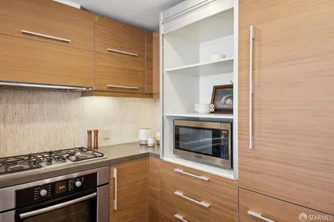 a stove top oven sitting inside of a kitchen