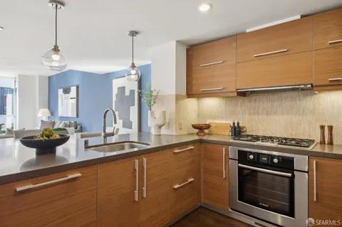 a large kitchen with stainless steel appliances granite countertop a sink and a stove