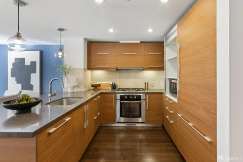 a kitchen with a sink a counter and chairs