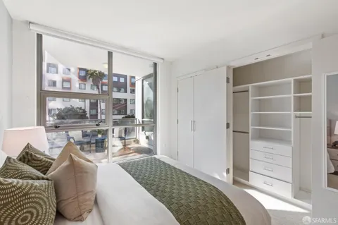 a bedroom with a bed and lamp with window