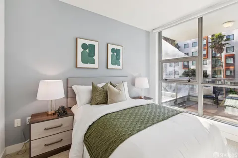a bedroom with a large bed and a book shelf