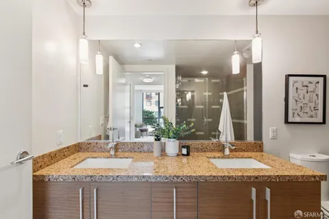 a bedroom with a bed and painting on the wall