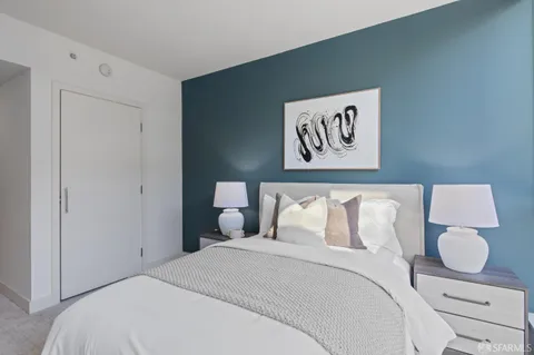 a bedroom with furniture and a large window