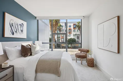 a balcony with furniture and a potted plant