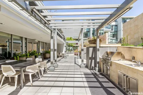a living room with lots of furniture and view of kitchen