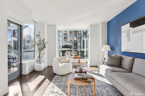 a living room with furniture a lamp and a window