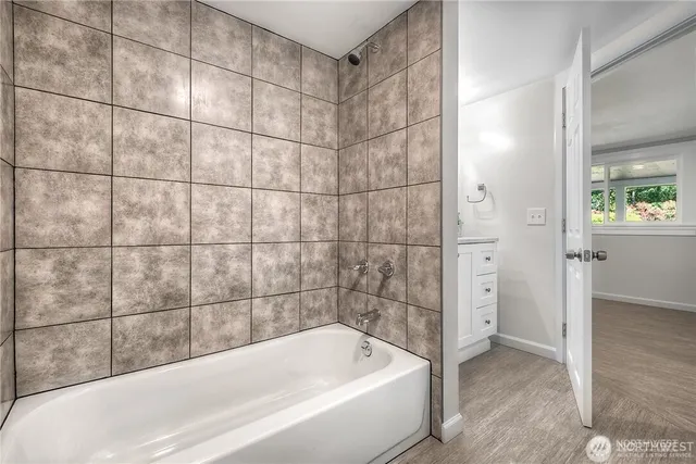 a bathroom with a bathtub and shower