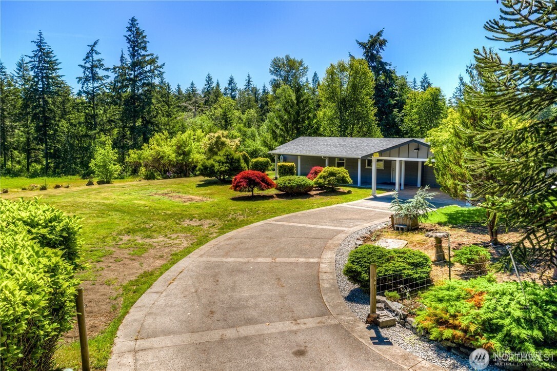 32407 72nd Avenue South Roy, WA 98580 - Photo 20 of 24 a view of a house with garden and trees