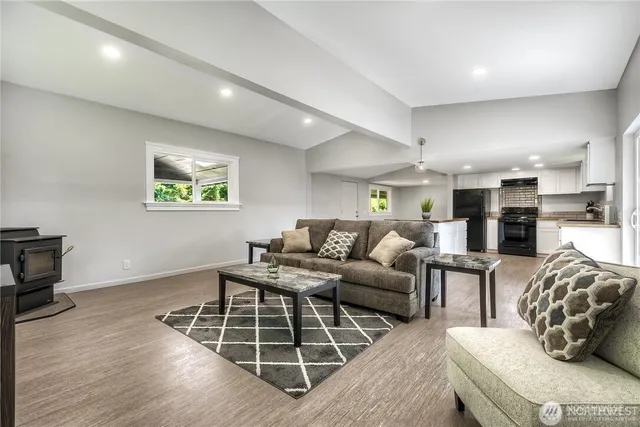 a living room with furniture window and a wooden floor
