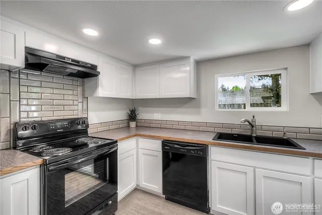 a kitchen with a sink stove and cabinets