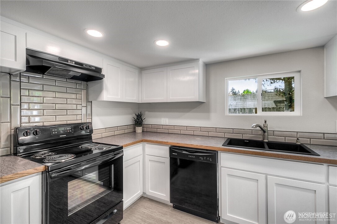 32407 72nd Avenue South Roy, WA 98580 - Photo 7 of 24 a kitchen with a sink stove and cabinets