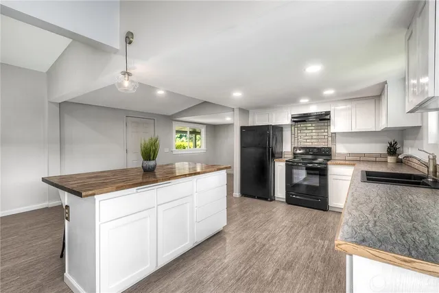 a kitchen with a sink stove and refrigerator