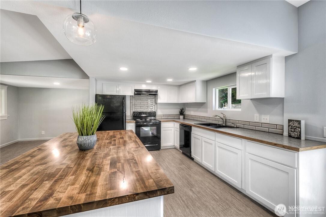 32407 72nd Avenue South Roy, WA 98580 - Photo 9 of 24 a kitchen with a refrigerator and white cabinets