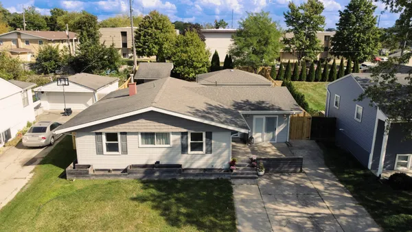 a aerial view of a house with yard and deck