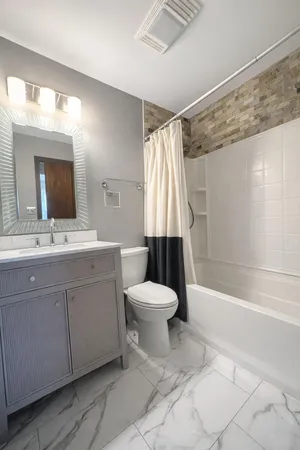 a bathroom with a sink toilet and shower
