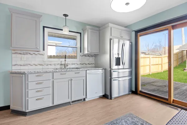 a kitchen with stainless steel appliances granite countertop a sink stove and refrigerator