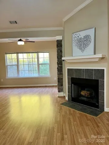 a view of an empty room with a fireplace and a window