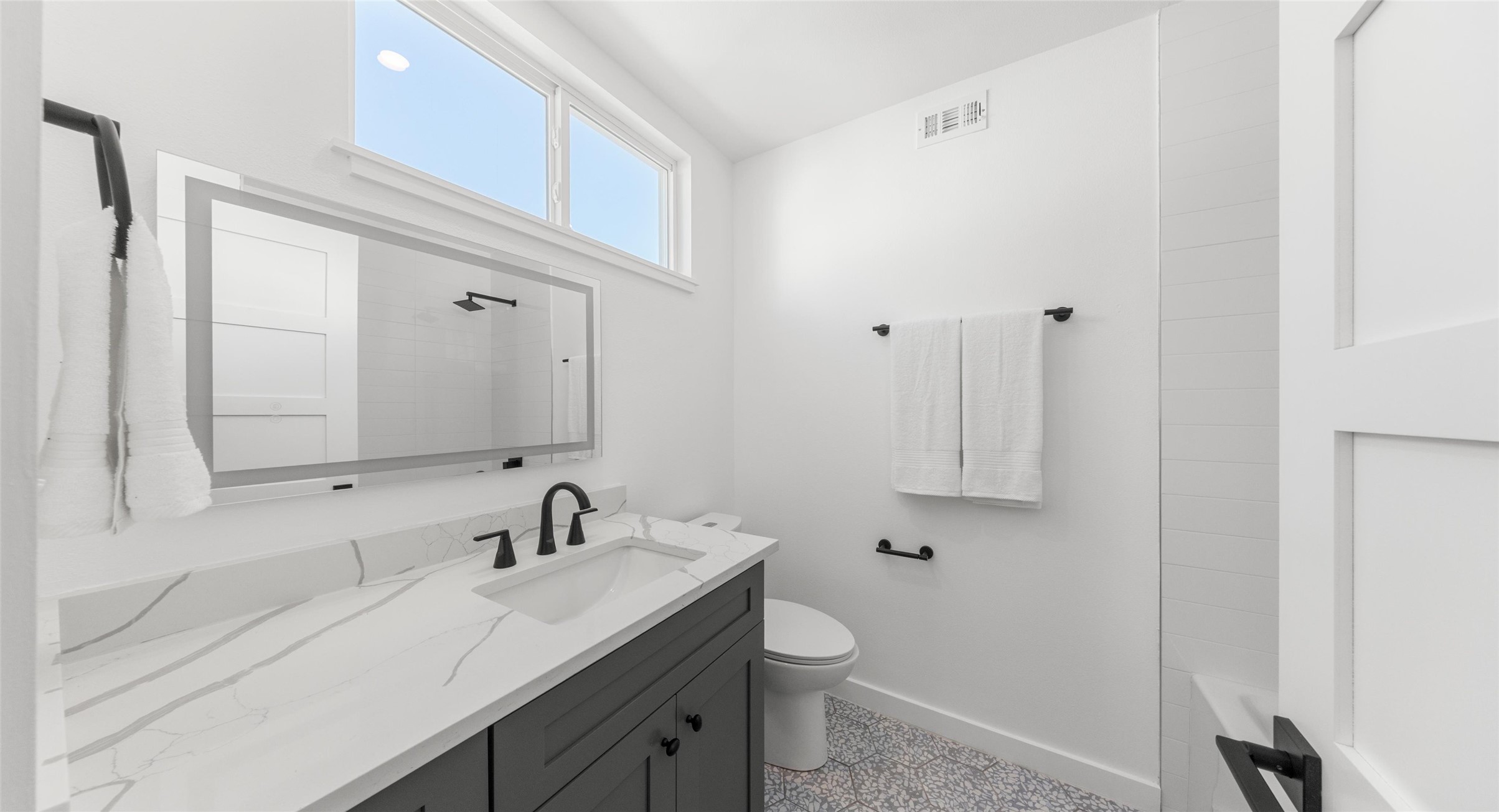 5912 Harold Court, Unit 107 Austin, TX 78721 - Photo 29 of 35 A vaulted-ceiling bath that feels airy and elevated, finished with clean, modern details. Model No. 105 Shown.