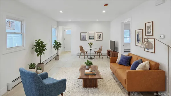 a living room with furniture and a potted plant